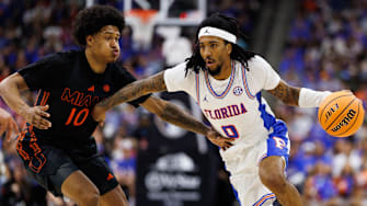 Nov 16, 2025; Jacksonville, Florida, USA; Florida Gators guard Boogie Fland (0) drives to the basket while Miami Hurricanes guard Tru Washington (10) defends during the first half at VyStar Veterans Memorial Arena. Mandatory Credit: Matt Pendleton-Imagn Images