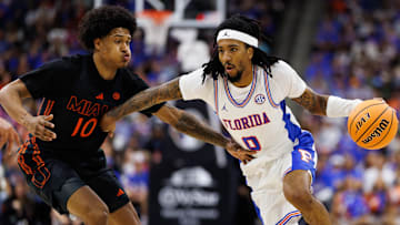 Nov 16, 2025; Jacksonville, Florida, USA; Florida Gators guard Boogie Fland (0) drives to the basket while Miami Hurricanes guard Tru Washington (10) defends during the first half at VyStar Veterans Memorial Arena. Mandatory Credit: Matt Pendleton-Imagn Images