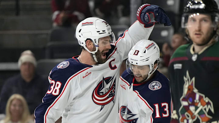 Mar 26, 2024; Tempe, Arizona, USA; Columbus Blue Jackets center Boone Jenner (38) celebrates with left wing Johnny Gaudreau (13) after scoring a goal against the Arizona Coyotes in the first period at Mullett Arena. Mandatory Credit: Rick Scuteri-Imagn Images