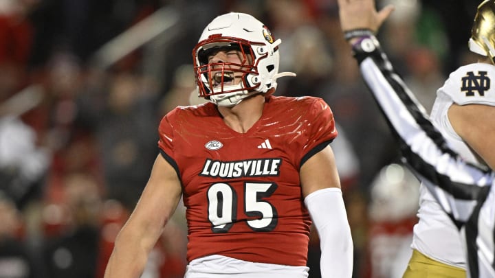 Oct 7, 2023; Louisville, Kentucky, USA;  Louisville Cardinals defensive lineman Mason Reiger (95) reacts after sacking Notre Dame Fighting Irish quarterback Sam Hartman (10) during the first half at L&N Federal Credit Union Stadium. 