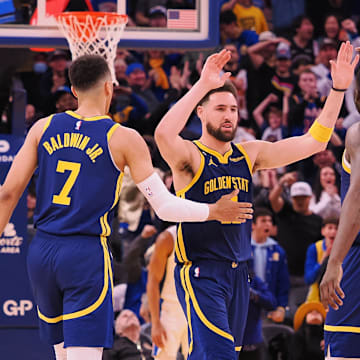 Jan 4, 2023; San Francisco, California, USA; Golden State Warriors shooting guard Klay Thompson (11) celebrates with small forward Patrick Baldwin (7), power forward Draymond Green (23) and shooting guard Donte DiVincenzo (0) after a play against the Detroit Pistons during the fourth quarter at Chase Center. Mandatory Credit: Kelley L Cox-Imagn Images