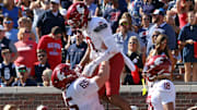Washington State Cougars offensive lineman Brock Dieu (65) lifts wide receiver Tony Freeman (0) after a touchdown during the fourth quarter om at Vaught-Hemingway Stadium.
