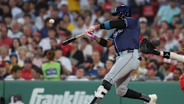 Boston, Massachusetts, USA; Tampa Bay Rays designated hitter Yandy Diaz (2) hits a two run home run during the fifth inning against the Boston Red Sox at Fenway Park.