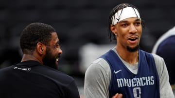 Jun 5, 2024; Boston, MA, USA;  Dallas Mavericks guard Kyrie Irving (11) and guard A.J. Lawson (9) laugh with teammates during the NBA Finals Media Day at TD Garden. Mandatory Credit: Peter Casey-USA TODAY Sports