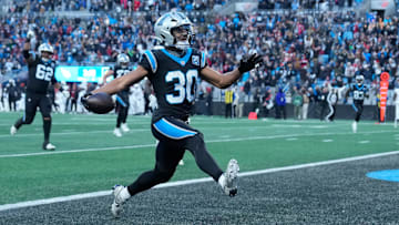 Carolina Panthers running back Chuba Hubbard (30) scores in overtime to win the game at Bank of America Stadium.