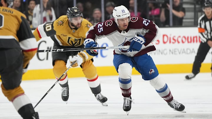 Oct 9, 2024; Las Vegas, Nevada, USA; Colorado Avalanche right wing Logan O’Connor (25) skates ahead of Vegas Golden Knights center Nicolas Roy (10) during the first period at T-Mobile Arena. Mandatory Credit: Lucas Peltier-Imagn Images