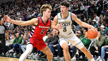 Nov 19, 2024; East Lansing, Michigan, USA; Michigan State Spartans forward Frankie Fidler (8) dribbles the ball against Samford Bulldogs guard Lukas Walls (2) during the second half at Jack Breslin Student Events Center. Mandatory Credit: Dale Young-Imagn Images