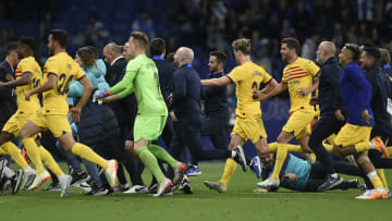 Barcelona's players flee after Espanyol supporters storm the pitch
