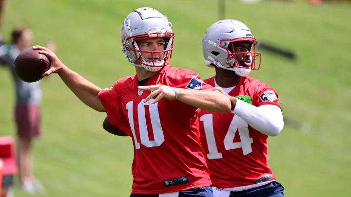 Jun 12, 2024; Foxborough, MA, USA;  New England Patriots quarterback Drake Maye (10) and quarterback Jacob y Brissett (14)  throw passes at minicamp at Gillette Stadium.  Mandatory Credit: Eric Canha-USA TODAY Sports