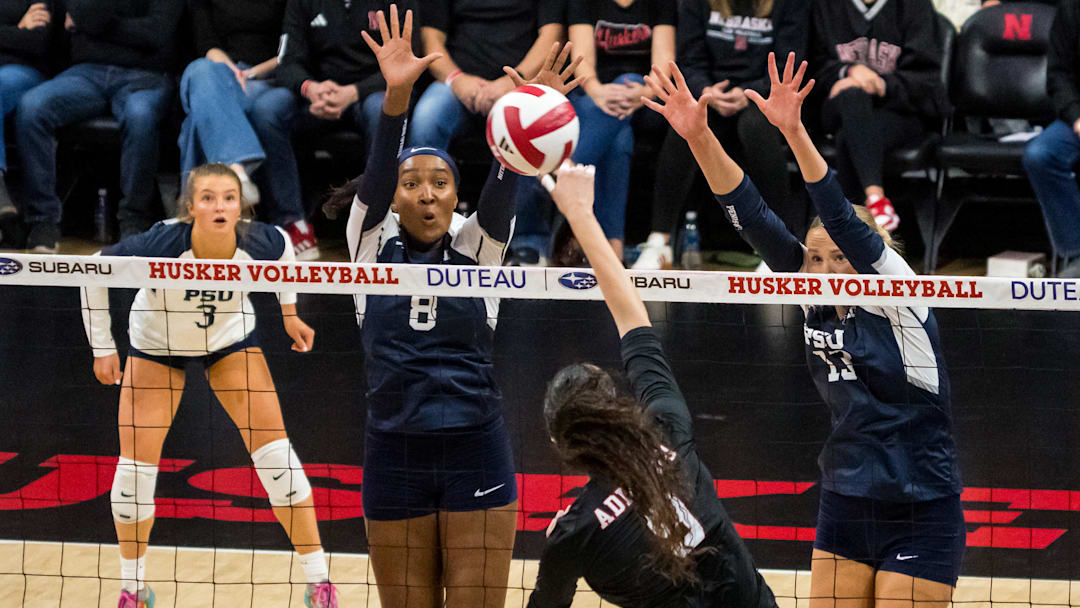 Nov 28, 2025; Lincoln, Neb, USA; Penn State Nittany Lions middle blocker Gabrielle Nichols (8) and Penn State Nittany Lions outside hitter Emmi Sellman (13) block Nebraska Cornhuskers opposite Virginia Adriano (9) during the third set at Bob Devaney Sports Center. Mandatory Credit: Dylan Widger-Imagn Images