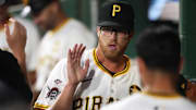 Aug 5, 2025; Pittsburgh, Pennsylvania, USA;  Pittsburgh Pirates relief pitcher Cam Sanders (64) high-fives in the dugout after pitching in his major league debut against the San Francisco Giants during the eighth inning at PNC Park. Mandatory Credit: Charles LeClaire-Imagn Images