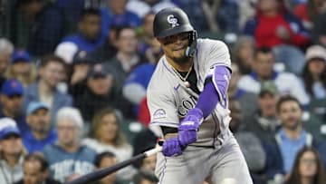 May 28, 2025; Chicago, Illinois, USA; Colorado Rockies designated hitter Orlando Arcia (8) hits a single against the Chicago Cubs during the third inning at Wrigley Field. Mandatory Credit: David Banks-Imagn Images
