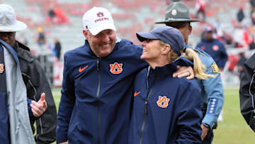 Oct 25, 2025; Fayetteville, Arkansas, USA; Auburn Tigers head coach Hugh Freeze and his wife Jill Freeze celebrate after the game against the Arkansas Razorbacks at Donald W. Reynolds Razorback Stadium. Auburn won 33-24. Mandatory Credit: Nelson Chenault-Imagn Images