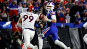 Buffalo Bills quarterback Josh Allen (17) looks downfield as he is pressured by Denver Broncos defensive end Zach Allen (99). Allen threw for 177 yards and a touchdown. HE also ran for a touchdown but the Bills lost to the Denver 24-22.