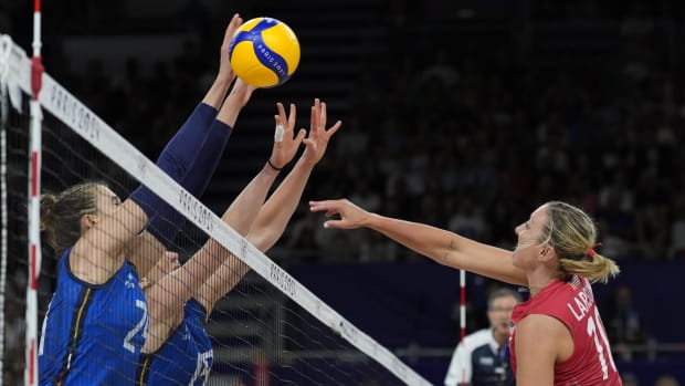 United States outside hitter Jordan Larson (10) hits to Italy opposite Ekaterina Antropova (24) and Italy middle blocker Sara