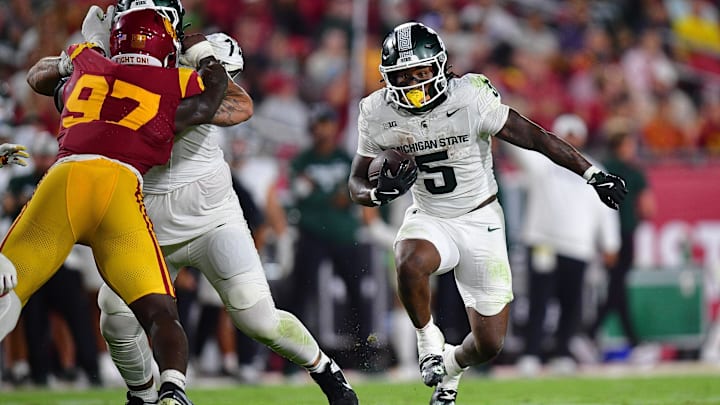 Sep 20, 2025; Los Angeles, California, USA; Michigan State Spartans running back Makhi Frazier (5) runs the ball against the Southern California Trojans during the second half at the Los Angeles Memorial Coliseum. Mandatory Credit: Gary A. Vasquez-Imagn Images