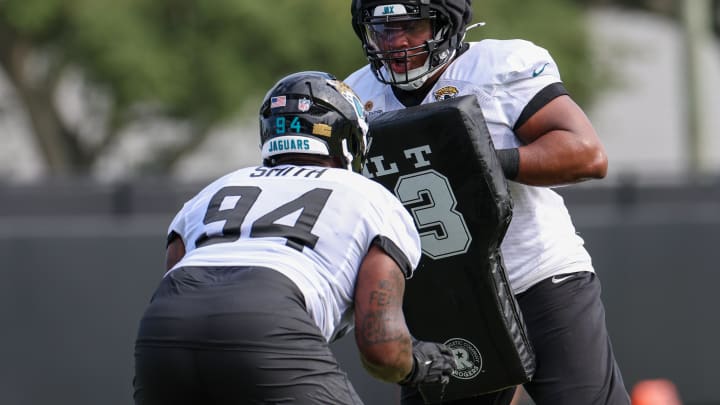 Jul 26, 2024; Jacksonville, FL, USA; Jacksonville Jaguars defensive tackle Maason Smith (94) and defensive end Jeremiah Ledbetter (99) participate in training camp at Miller Electric Center. Mandatory Credit: Nathan Ray Seebeck-USA TODAY Sports