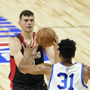 Jul 15, 2024; Las Vegas, NV, USA; Portland Trail Blazers center Donovan Clingan (23) shoots the ball against Philadelphia 76ers center Tony Bradley (31) during the first half at Thomas & Mack Center. Mandatory Credit: Lucas Peltier-USA TODAY Sports