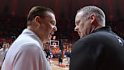 Jan 21, 2024; Champaign, Illinois, USA; Illinois Fighting Illini head coach Brad Underwood, left, and Rutgers Scarlet Knights head coach Steve Pikiell talk before a game at State Farm Center. Mandatory Credit: Ron Johnson-Imagn Images