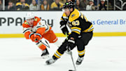 Feb 22, 2025; Boston, Massachusetts, USA; Boston Bruins left wing Brad Marchand (63) controls the puck against Anaheim Ducks defenseman Jackson LaCombe (2) during the first period at TD Garden. Mandatory Credit: Bob DeChiara-Imagn Images