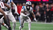 Carolina Panthers running back Miles Sanders runs the ball against the Atlanta Falcons.