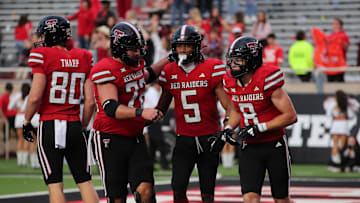 Oct 19, 2024; Lubbock, Texas, USA;  Texas Tech Red Raiders wide receiver Caleb Douglas (5) celebrates with wide receiver Coy Eakin (8) and center Sheridan Wilson (72) after a touchdown against the Baylor Bears in the second half at Jones AT&T Stadium and Cody Campbell Field. Mandatory Credit: Michael C. Johnson-Imagn Images