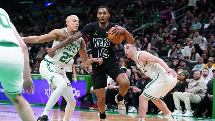 Feb 14, 2024; Boston, Massachusetts, USA; Brooklyn Nets guard Keon Johnson (45) drives the ball against Boston Celtics guard Payton Pritchard (11) and guard Jordan Walsh (27) in the second half at TD Garden. Mandatory Credit: David Butler II-USA TODAY Sports