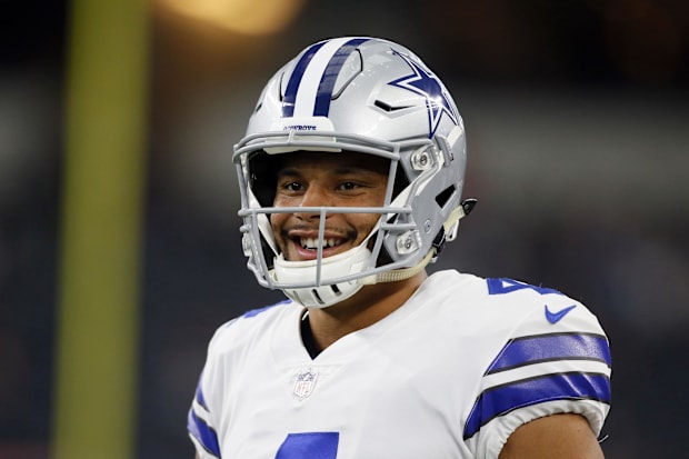 Dallas Cowboys quarterback Dak Prescott smiles while on the field before the game against the Raiders.