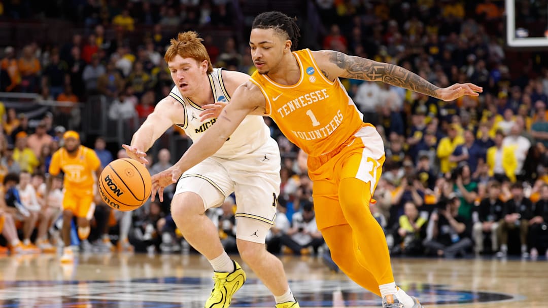 Mar 29, 2026; Chicago, IL, USA; Michigan Wolverines forward Oscar Goodman (5) and Tennessee Volunteers guard Amari Evans (1) battle for the ball in the second half during an Elite Eight game of the Midwest Regional of the men's 2026 NCAA Tournament at United Center. Mandatory Credit: Kamil Krzaczynski-Imagn Images Mar 29, 2026; Chicago, IL, USA; Michigan Wolverines forward Oscar Goodman (5) and Tennessee Volunteers guard Amari Evans (1) battle for the ball in the second half during an Elite Eight game of the Midwest Regional of the men's 2026 NCAA Tournament at United Center. Mandatory Credit: Kamil Krzaczynski-Imagn Images