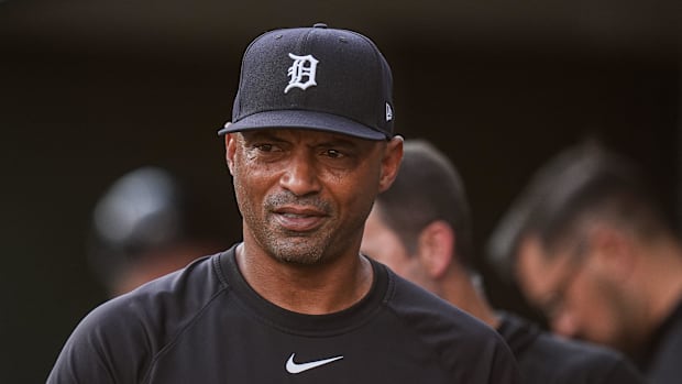 Detroit Tigers bench coach George Lombard looks on in a blue hat and blue shirt.
