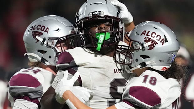 Alcoa's Cade Stinnett (24), Micah Jones (9), and Thomas Manu (18) celebrating after Jones recovered a fumble during the TSSAA