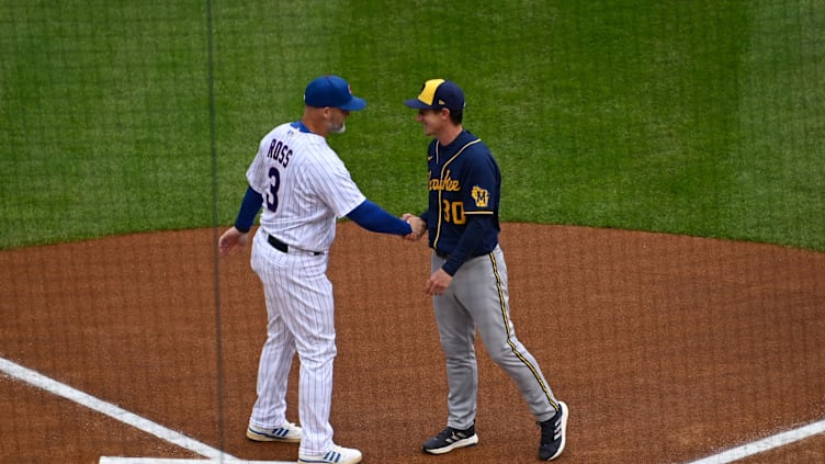 Apr 7, 2022; Chicago, Illinois, USA;  Chicago Cubs manager David Ross (3) and Milwaukee Brewers