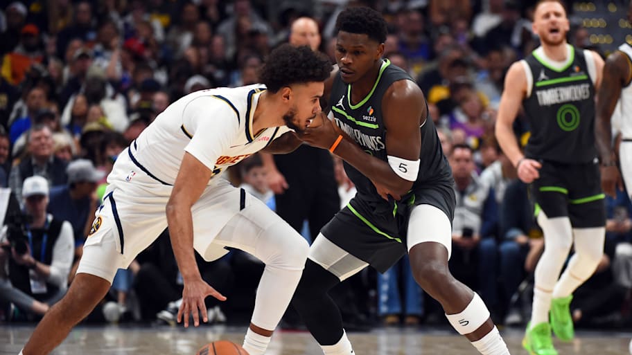 Denver Nuggets forward Cameron Johnson is defended by Minnesota Timberwolves guard Anthony Edwards.
