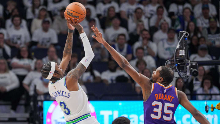 Apr 23, 2024; Minneapolis, Minnesota, USA; Minnesota Timberwolves forward Jaden McDaniels (3) shoots against Phoenix Suns forward Kevin Durant (35) in the second quarter during game two of the first round for the 2024 NBA playoffs at Target Center. Mandatory Credit: Brad Rempel-USA TODAY Sports