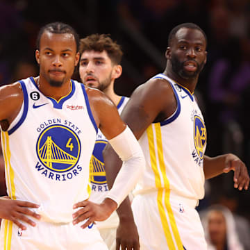 Oct 25, 2022; Phoenix, Arizona, USA; Golden State Warriors guard Moses Moody (4), forward Jonathan Kuminga (00) and forward Draymond Green (23) against the Phoenix Suns at Footprint Center. Mandatory Credit: Mark J. Rebilas-Imagn Images