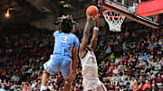 Mar 4, 2025; Blacksburg, Virginia, USA;  Virginia Tech Hokies guard Tyler Johnson (10) goes up for a shot as North Carolina Tar Heels guard Elliot Cadeau (3) defends during the first half at Cassell Coliseum. Mandatory Credit: Brian Bishop-Imagn Images