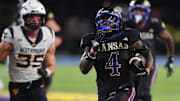 Kansas Jayhawks running back Leshon Williams (4) runs the ball in for a touchdown during the second half of the game against West Virginia Mountaineers at David Booth Kansas Memorial Stadium on Sept. 20, 2025.