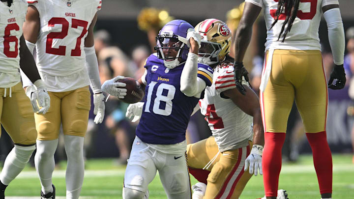 Sep 15, 2024; Minneapolis, Minnesota, USA; Minnesota Vikings wide receiver Justin Jefferson (18) reacts as San Francisco 49ers linebacker Fred Warner (54) looks on during the second quarter U.S. Bank Stadium. Mandatory Credit: Jeffrey Becker-Imagn Images