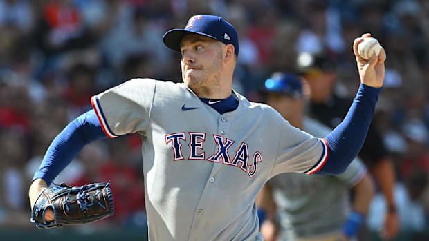 Texas Rangers starting pitcher Patrick Corbin throws in a gray uniform and blue hat