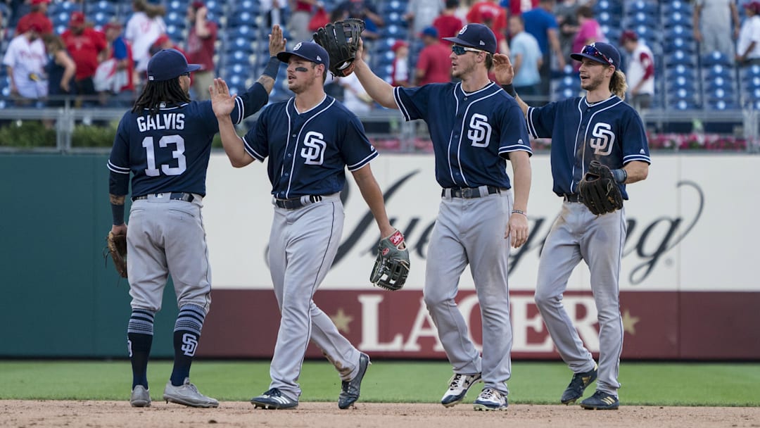 San Diego Padres shortstop Freddy Galvis (13) hi fives with San Diego Padres right fielder Will Myers (4) and San Diego Padres right fielder Hunter Renfroe (10) and San Diego Padres center fielder Travis Jankowski (16) after the last out in the ninth inning of the game against the Philadelphia Phillies at Citizens Bank Park on July 22, 2018.