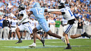 Nov 22, 2025; Chapel Hill, North Carolina, USA; Duke Blue Devils quarterback Darian Mensah (10) rushes for a first down during the first half at Kenan Stadium. Mandatory Credit: William Howard-Imagn Images