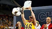 Wyoming Cowboys kicker John Hoyland celebrates with the MVP trophy after defeating the Toledo Rockets in the Arizona Bowl.