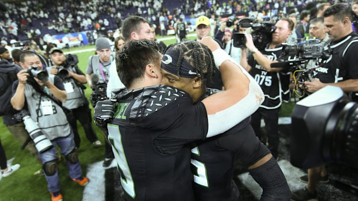 Dec 7, 2024; Indianapolis, IN, USA; Oregon Ducks quarterback Dillon Gabriel (8) hugs wide receiver Tez Johnson (15) after defeating the Penn State Nittany Lions to win the Big Ten Championship in the 2024 Big Ten Championship game at Lucas Oil Stadium. Mandatory Credit: Robert Goddin-Imagn Images Dec 7, 2024; Indianapolis, IN, USA; Oregon Ducks quarterback Dillon Gabriel (8) hugs wide receiver Tez Johnson (15) after defeating the Penn State Nittany Lions to win the Big Ten Championship in the 2024 Big Ten Championship game at Lucas Oil Stadium. Mandatory Credit: Robert Goddin-Imagn Images