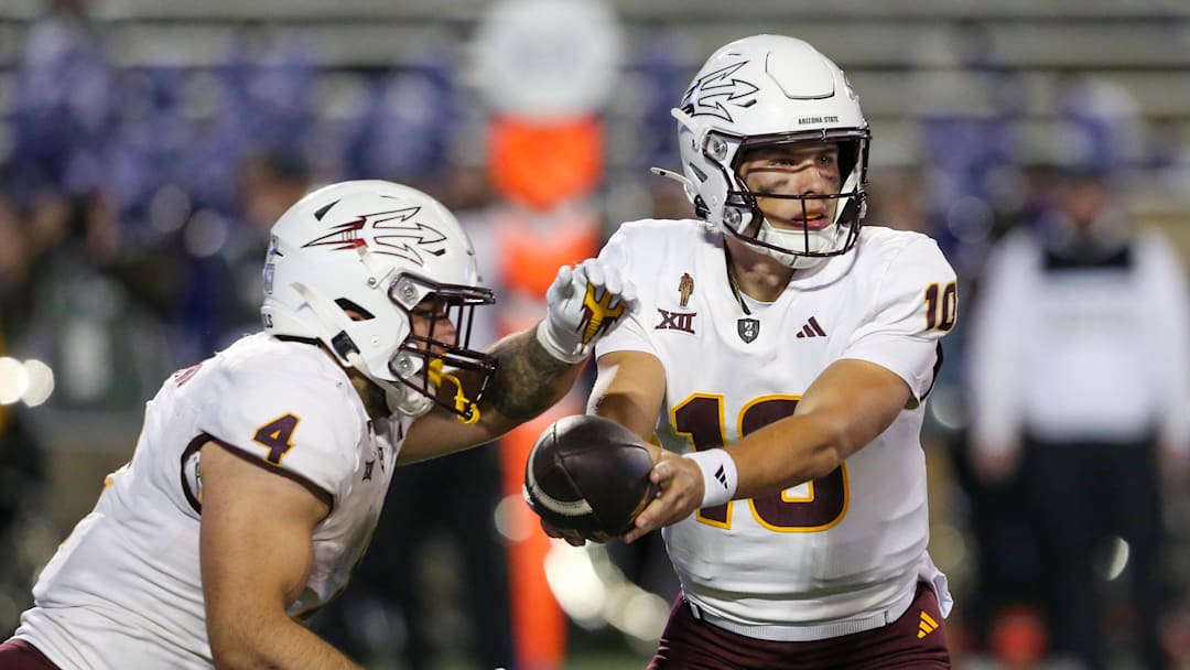 Nov 16, 2024; Manhattan, Kansas, USA; Arizona State Sun Devils quarterback Sam Leavitt (10) hands off to running back Cam Skattebo (4) against the Kansas State Wildcats during the second quarter at Bill Snyder Family Football Stadium. Mandatory Credit: Scott Sewell-Imagn Images