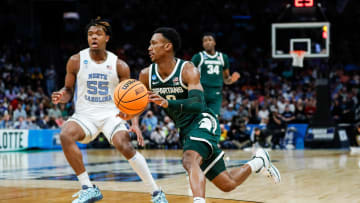 Michigan State guard Tyson Walker (2) dribbles against North Carolina forward Harrison Ingram (55) during the second half of the NCAA tournament West Region second round at Spectrum Center in Charlotte, N.C. on Saturday, March 23, 2024.