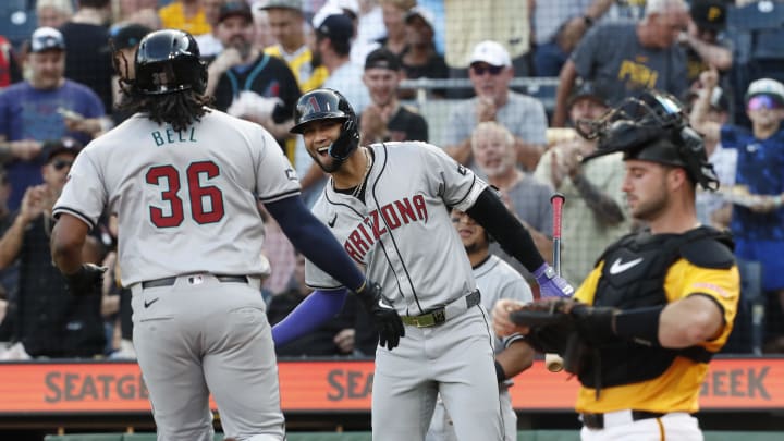 Arizona Diamondbacks left fielder Lourdes Gurriel Jr. (middle)  congratulates first baseman Josh Bell (36) crossing home plate on a solo home run against the Pittsburgh Pirates during the first inning at PNC Park on Aug 2.