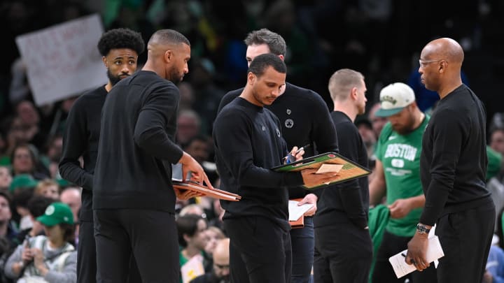 Apr 5, 2024; Boston, Massachusetts, USA; Boston Celtics head coach Joe Mazzulla (center) works with coaching staff to diagram a play during the first half against the Sacramento Kings at TD Garden. Mandatory Credit: Eric Canha-USA TODAY Sports