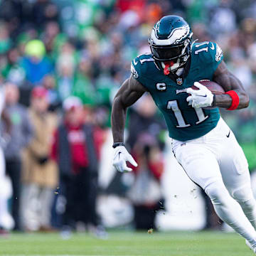 Dec 31, 2023; Philadelphia, Pennsylvania, USA; Philadelphia Eagles wide receiver A.J. Brown (11) runs with the ball during the fourth quarter against the Arizona Cardinals at Lincoln Financial Field. Mandatory Credit: Bill Streicher-Imagn Images