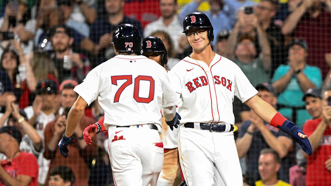Jun 12, 2024; Boston, Massachusetts, USA; Boston Red Sox shortstop David Hamilton (70) high-fives first base Bobby Dalbec (29) after hitting a two-run home run against the Philadelphia Phillies during the sixth inning at Fenway Park. Mandatory Credit: Brian Fluharty-Imagn Images