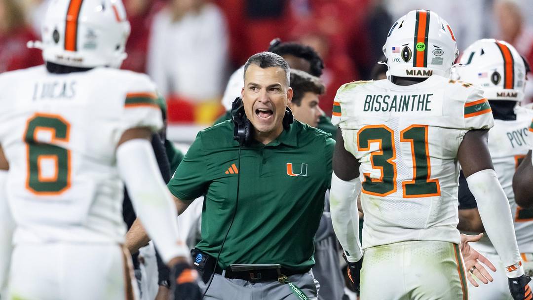 Jan 19, 2026; Miami Gardens, FL, USA; Miami Hurricanes head coach Mario Cristobal with linebacker Wesley Bissainthe (31) against the Indiana Hoosiers during the College Football Playoff National Championship game at Hard Rock Stadium. Mandatory Credit: Mark J. Rebilas-Imagn Images